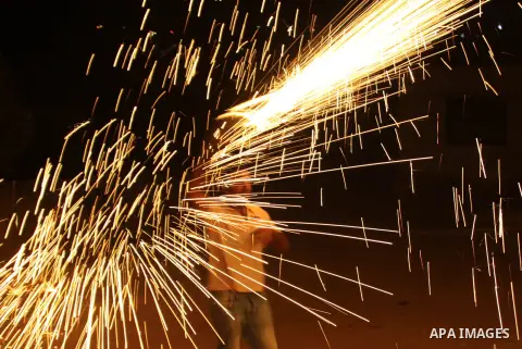 A Palestinian man lights fireworks to celebrate the second day of the Muslim Holy fasting month of Ramadan in the West bank city of Nablus on 21 July 2012. Muslims throughout the world are celebrating the fasting month o...