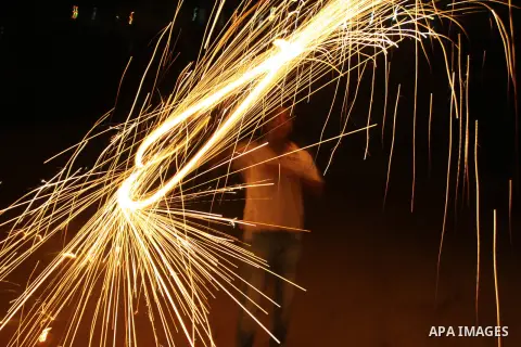 A Palestinian man lights fireworks to celebrate the second day of the Muslim Holy fasting month of Ramadan in the West bank city of Nablus on 21 July 2012. Muslims throughout the world are celebrating the fasting month o...