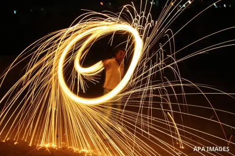 A Palestinian man lights fireworks to celebrate the second day of the Muslim Holy fasting month of Ramadan in the West bank city of Nablus on 21 July 2012. Muslims throughout the world are celebrating the fasting month o...