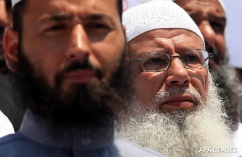 Palestinians member of the Ministry of Awqaf and Religious Affairs, during a demonstration calling to stop killing the Burmese Muslims in Myanmar, in Gaza City, July 22, 2012. Dozens of Muslims were killed and thousands...