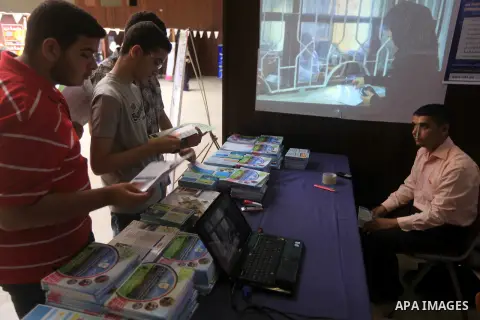 Palestinian students participate in the exhibition for Palestine colleges in the Rashad Shawa Center in Gaza City, on July 22, 2012.. Photo by Majdi Fathi