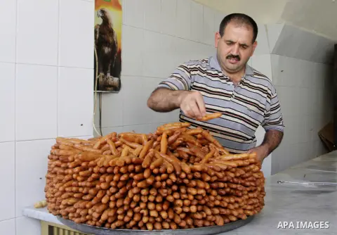 A Palestinian sweet-maker prepares sweets consumed during Ramadan in the West Bank city of Nablus, on July 22, 2012. Muslims around the world abstain from eating, drinking and conducting sexual relations from dawn till d...