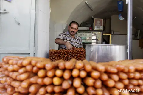 A Palestinian sweet-maker prepares sweets consumed during Ramadan in the West Bank city of Nablus, on July 22, 2012. Muslims around the world abstain from eating, drinking and conducting sexual relations from dawn till d...