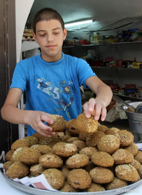 A Palestinian prepares traditional Falafel during Ramadan in the West Bank city of Nablus, on July 22, 2012. Muslims around the world abstain from eating, drinking and conducting sexual relations from dawn till dusk duri...