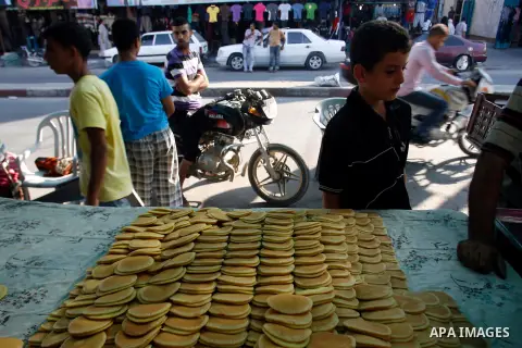 A Palestinian man prepares traditional pancake known as "Qatayef" consumed during Ramadan in Rafah in the south of Gaza strip, on July 22, 2012. Muslims around the world abstain from eating, drinking and conducting sexua...