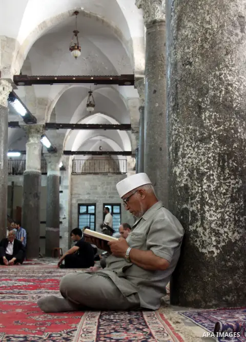 Palestinians read the holy Qur'an at the mosque in West Bank City of Nablus, on 23 July 2012. Muslims around the world refrain from eating, drinking and sexual intercourse from dawn till dusk during Ramadan, the holiest...