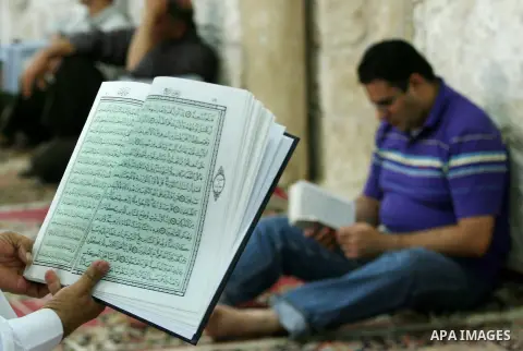 Palestinians read the holy Qur'an at the mosque in West Bank City of Nablus, on 23 July 2012. Muslims around the world refrain from eating, drinking and sexual intercourse from dawn till dusk during Ramadan, the holiest...