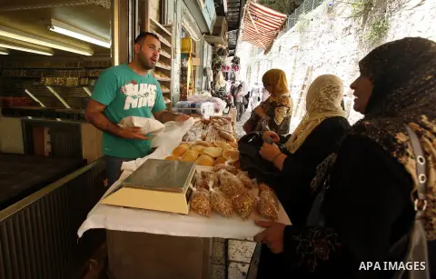 A Palestinian man sells traditional pancake known as "Qatayef" consumed during Ramadan in Jerusalem's old city, on July 23, 2012. Muslims around the world abstain from eating, drinking and conducting sexual relations fro...