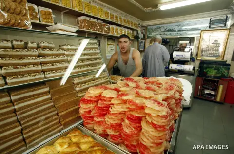A Palestinian vendor sells traditional sweets consumed during Ramadan at the market of Jerusalem's old city, on July 23, 2012. Muslims around the world abstain from eating, drinking and conducting sexual relations from d...