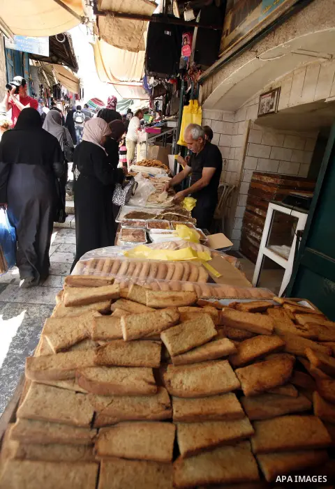 A Palestinian vendor sells bagels during Ramadan at the market of Jerusalem's old city, on July 23, 2012. Muslims around the world abstain from eating, drinking and conducting sexual relations from dawn till dusk during...