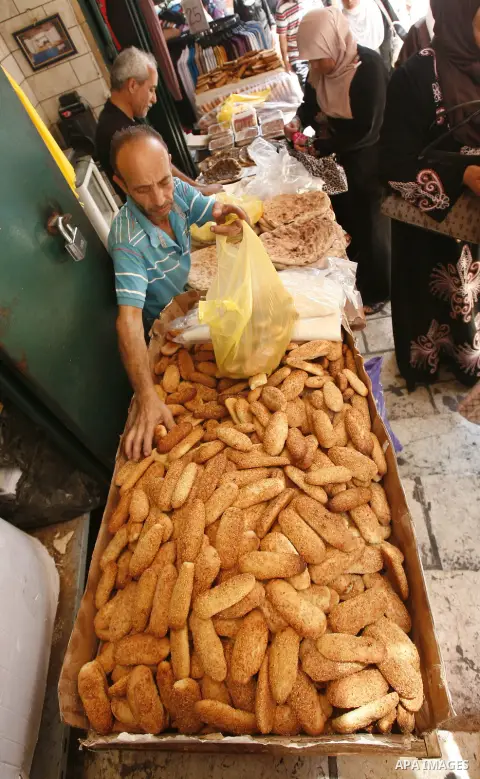 A Palestinian vendor sells bagels during Ramadan at the market of Jerusalem's old city, on July 23, 2012. Muslims around the world abstain from eating, drinking and conducting sexual relations from dawn till dusk during...