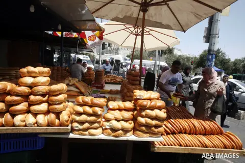 Palestinian vendors sell bread during Ramadan at the market of Jerusalem's old city, on July 23, 2012. Muslims around the world abstain from eating, drinking and conducting sexual relations from dawn till dusk during Ram...