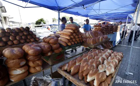 Palestinian vendors sell bread during Ramadan at the market of Jerusalem's old city, on July 23, 2012. Muslims around the world abstain from eating, drinking and conducting sexual relations from dawn till dusk during Ram...