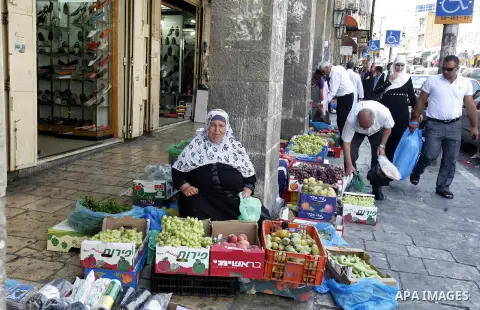 A Palestinian woman sells fruits during Ramadan in Jerusalem's old city, on July 23, 2012. Muslims around the world abstain from eating, drinking and conducting sexual relations from dawn till dusk during Ramadan, the ho...