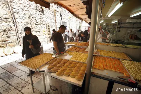 A Palestinian vendor sells traditional sweets consumed during Ramadan at the market of Jerusalem's old city, on July 23, 2012. Muslims around the world abstain from eating, drinking and conducting sexual relations from d...