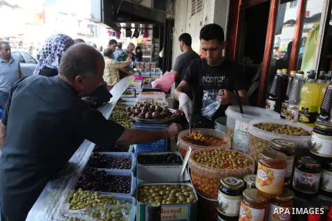 A Palestinian vendor sells pickles during the fasting month of Ramadan in the West Bank city of Ramallah, on July 23, 2012. Muslims around the world abstain from eating, drinking and conducting sexual relations from dawn...