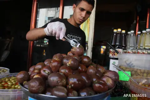 A Palestinian vendor sells pickles during the fasting month of Ramadan in the West Bank city of Ramallah, on July 23, 2012. Muslims around the world abstain from eating, drinking and conducting sexual relations from dawn...