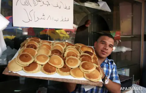 A Palestinian vendor sells traditional pancake known as ''Qatayef'' consumed during the fasting month of Ramadan in the West Bank city of Ramallah, on July 23, 2012. Muslims around the world abstain from eating, drinking...