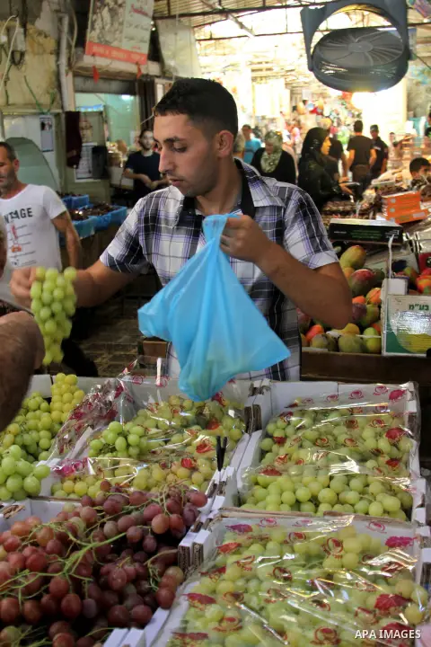 Palestinians shop at the traditional market in the West Bank city of Nablus, on the five day of the holy month of Ramadan ,on 24 July 2012. Muslims around the world abstain from eating, drinking and conducting sexual rel...