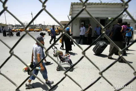 Palestinians wait the buses to cross to Egypt through the Rafah border crossing between the Gaza Strip and Egypt in Gaza city, on 24 July 2012. Egyptian Ambassador of Arab Republic , of the Palestinian Authority, Yasser...