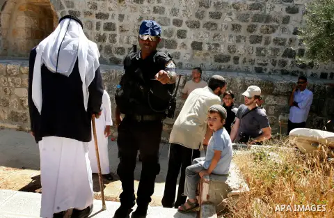 Jewish settlers walk past the Al-Aqsa mosque compound, Islam's third holiest site, during a visit under Israeli police protection in Jerusalem's old city on July 24, 2012. Photo by Mahfouz Abu Turk
