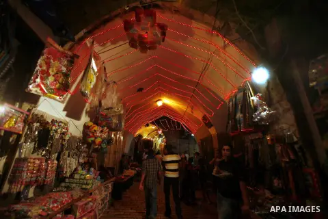 Palestinian vendors decorate their shops in Jerusalem's Old City during the holy month of Ramadan, on 25 July 2012. Muslims around the world abstain from eating, drinking and conducting sexual relations from dawn till du...