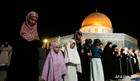 Palestinian worshippers pray in front of dome of the rock near al-Aqsa Mosque in Jerusalem's Old City during the holy month of Ramadan, on 25 July 2012. Muslims around the world abstain from eating, drinking and conducti...