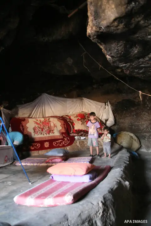Palestinian children who live in caves near the Palestinian village of Jimba , south of Yatta, near the West Bank town of Hebron, rest on a mattress outside their home on July 25, 2012. The Israeli Defence Minister, Ehud...