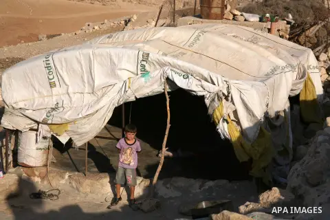 A Palestinian child who lives in caves near the Palestinian village of Jimba , south of Yatta, near the West Bank town of Hebron, rest on a mattress outside their home on July 25, 2012. The Israeli Defence Minister, Ehud...