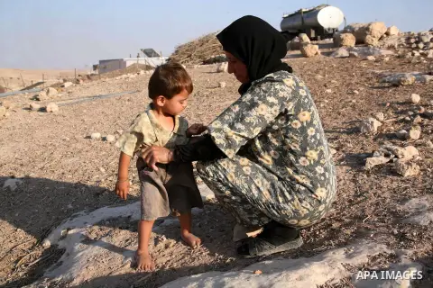 A Palestinian woman looks after her children in a cave, where they live, near the Palestinian village of Jimba, south of Yatta, near the West Bank town of Hebron on July 25, 2012. The Israeli Defence Minister, Ehud Barak...