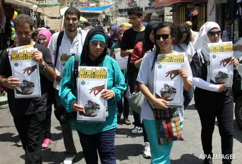 Palestinian youths demonstrate for a boycott of Israeli goods and support national products during a protest in the West Bank city of Nablus,on July 26,2012. Photo by Nedal Shtieh . Photo by Nedal Eshtayah