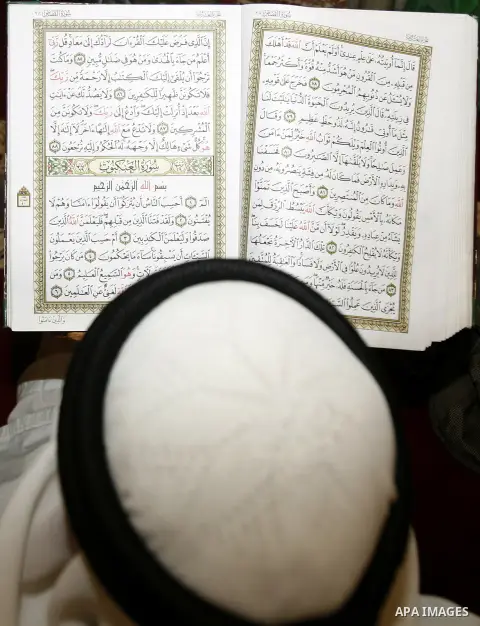 Palestinian reads the holy Qur'an at dome of the rock near al-Aqsa Mosque in Jerusalem's Old City during the holy month of Ramadan, on 26 July 2012. Muslims around the world abstain from eating, drinking and conducting s...