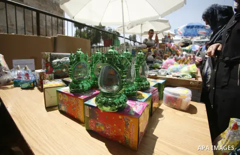 A Palestinian vendor displays goods in front of his shop in Jerusalem's Old City during the holy month of Ramadan, on 26 July 2012. Muslims around the world abstain from eating, drinking and conducting sexual relations f...