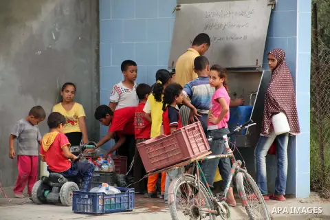 Palestinians fill their bottles a potable water at a water purification station, in Deir al-Balah central Gaza Strip, on July 26. 2012. Palestinians suffer from the severe lack of potable water during the holy fasting mo...