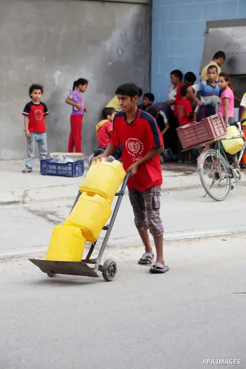Palestinians fill their bottles a potable water at a water purification station, in Deir al-Balah central Gaza Strip, on July 26. 2012. Palestinians suffer from the severe lack of potable water during the holy fasting mo...