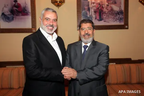 Egyptian President Mohamed Morsi (R) meets with Palestinian Prime Minister in Gaza Ismail Haniyeh and members of Hamas leaders at the presidential palace, in Cairo, Egypt, 26 July 2012. Haniyeh is visiting Egypt for talk...