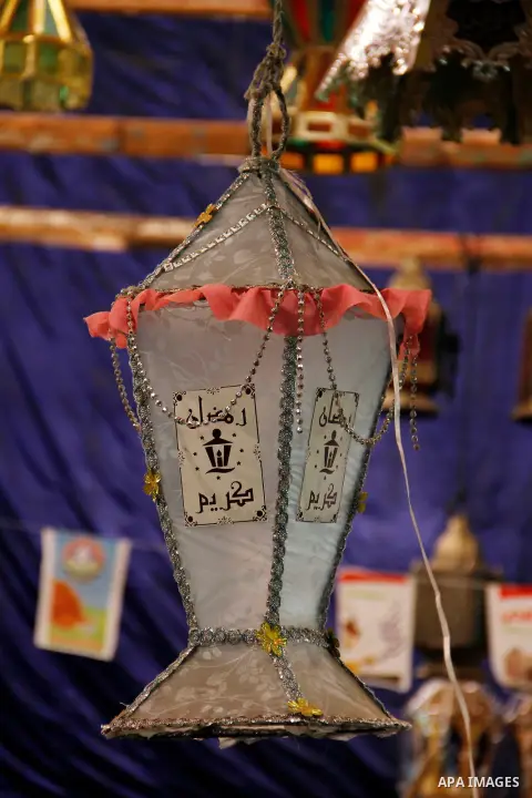 Egyptians hangs Ramadan lanterns (or Fanoos Ramadan) that are displayed for sale at a shop during the Muslim fasting month of Ramadan, in Cairo July 26, 2012. Photo by Amr Mostafa