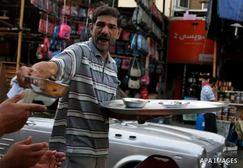 Egyptian people getting ready for break their fast at the dinner table, in Cairo on 26 July 2012. Egyptians prepare to have an break their fast meal during fasting holy month of Ramadan, which is the Muslim month of fast...