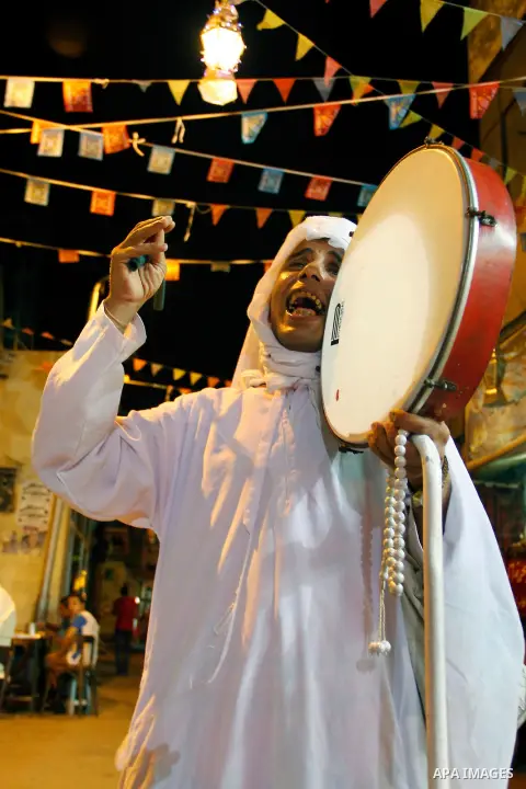 Egyptian man beats drum to wake up muslims for getting the dawn meal preparing for fasting a new day, in Cairo on 26 July 2012 during fasting holy month of Ramadan, which is the Muslim month of fasting, in which Muslims...