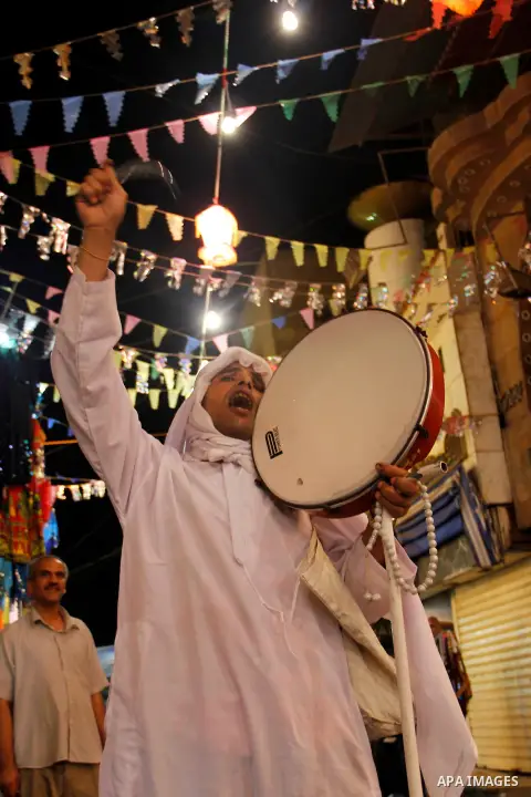 Egyptian man beats drum to wake up muslims for getting the dawn meal preparing for fasting a new day, in Cairo on 26 July 2012 during fasting holy month of Ramadan, which is the Muslim month of fasting, in which Muslims...