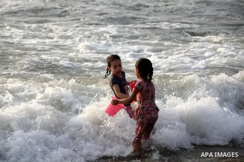 Palestinian children enjoy swimming at Gaza beach during the fasting holy month of Ramadan, in Gaza city on 26 July 2012. Photo by Majdi Fathi
