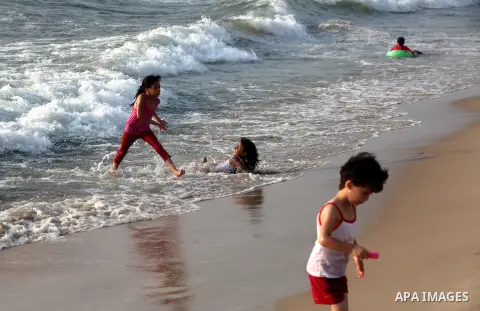 Palestinian children enjoy swimming at Gaza beach during the fasting holy month of Ramadan, in Gaza city on 26 July 2012. Photo by Majdi Fathi