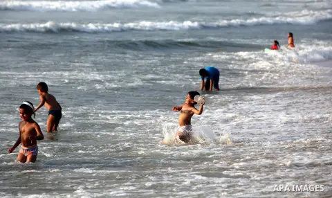 Palestinian children enjoy swimming at Gaza beach during the fasting holy month of Ramadan, in Gaza city on 26 July 2012. Photo by Majdi Fathi
