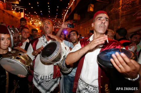 Palestinian musicians perform in Jerusalem's Old City during celebrations to mark the breaking of the fast on the seventh day of the holy month of Ramadan, on July 26, 2012. Photo by Mahfouz Abu Turk
