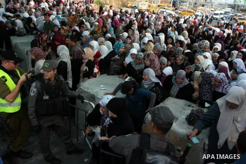 Israeli border policemen check the ID cards of Palestinian women at Qalandiya checkpoint outside the West Bank city of Ramallah July 27, 2012, as they make their way to Jerusalem on the second Friday of the holy month of...