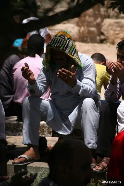 Palestinians perform the second Friday prayers of the Muslim fasting month of Ramadan outside the Ibrahimi Mosque or the Tomb of the Patriarchs in the West Bank city of Hebron on July 27, 2012. Photo by Mamoun Wazwaz