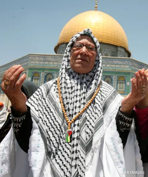 Palestinian worshippers pray outside al-Aqsa mosque in Jerusalem's Old City on the Second Friday of the holy month of Ramadan July 27, 2012. Israeli police said that Palestinian over the age of 40 would be freely permitt...