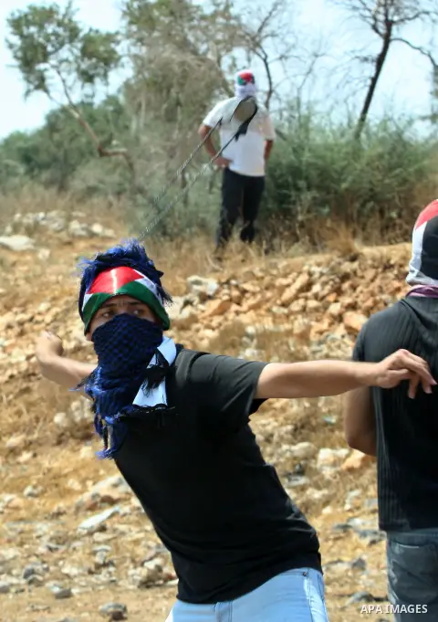 Palestinian protesters throw stones towards Israeli soldiers during clashes following a demonstrator against the expropriation of Palestinian land by Israel in the village of Kafr Qaddum, near the West Bank city of Nablu...