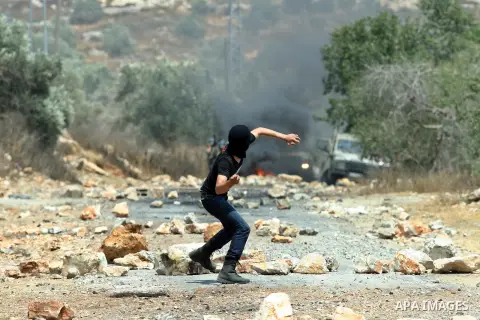 Palestinian protesters throw stones towards Israeli soldiers during clashes following a demonstrator against the expropriation of Palestinian land by Israel in the village of Kafr Qaddum, near the West Bank city of Nablu...
