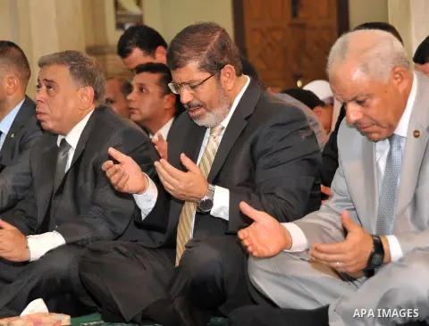 Egyptian President Mohamed Morsi performing Friday noon prayers at a mosque in the district of Fayoum, south west of Cairo, during the Muslim holy fasting month of Ramadan, on July 27, 2012. Photo by Egyptian Presidency